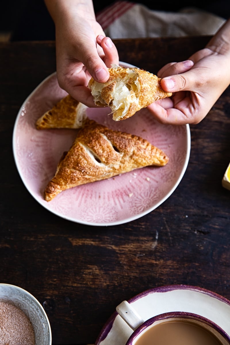 hands holding apple turnovers