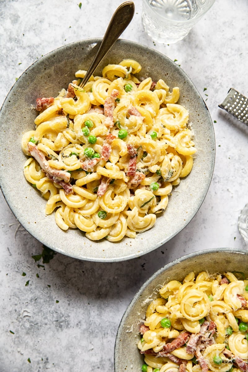 top down photo of two bowls of pasta with a fork inserted