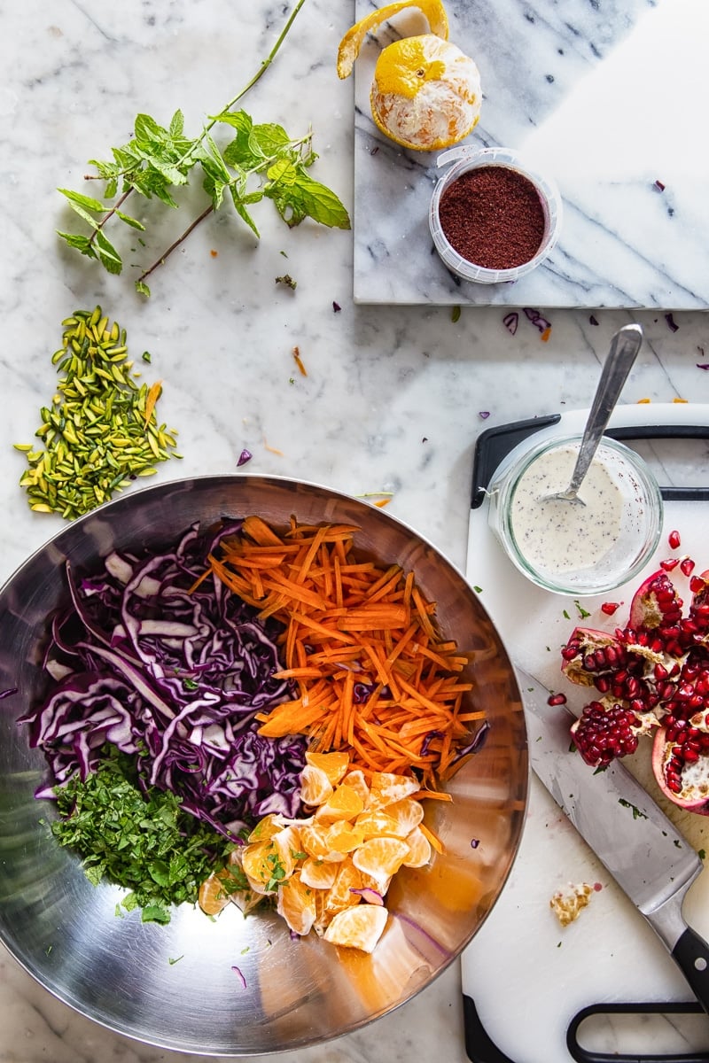 Process shot of slaw ingredients in a bowl