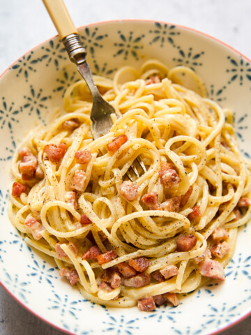 Bowl of spaghetti carbonara with a fork