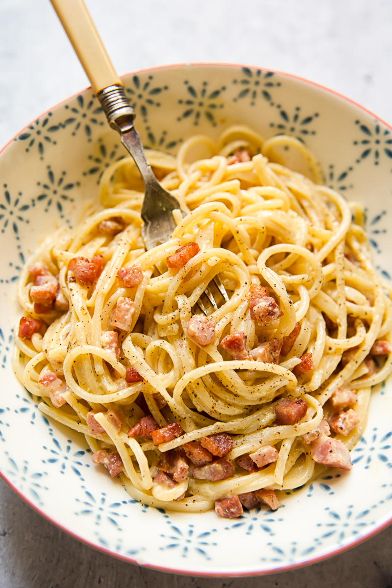 Bowl of spaghetti carbonara with a fork