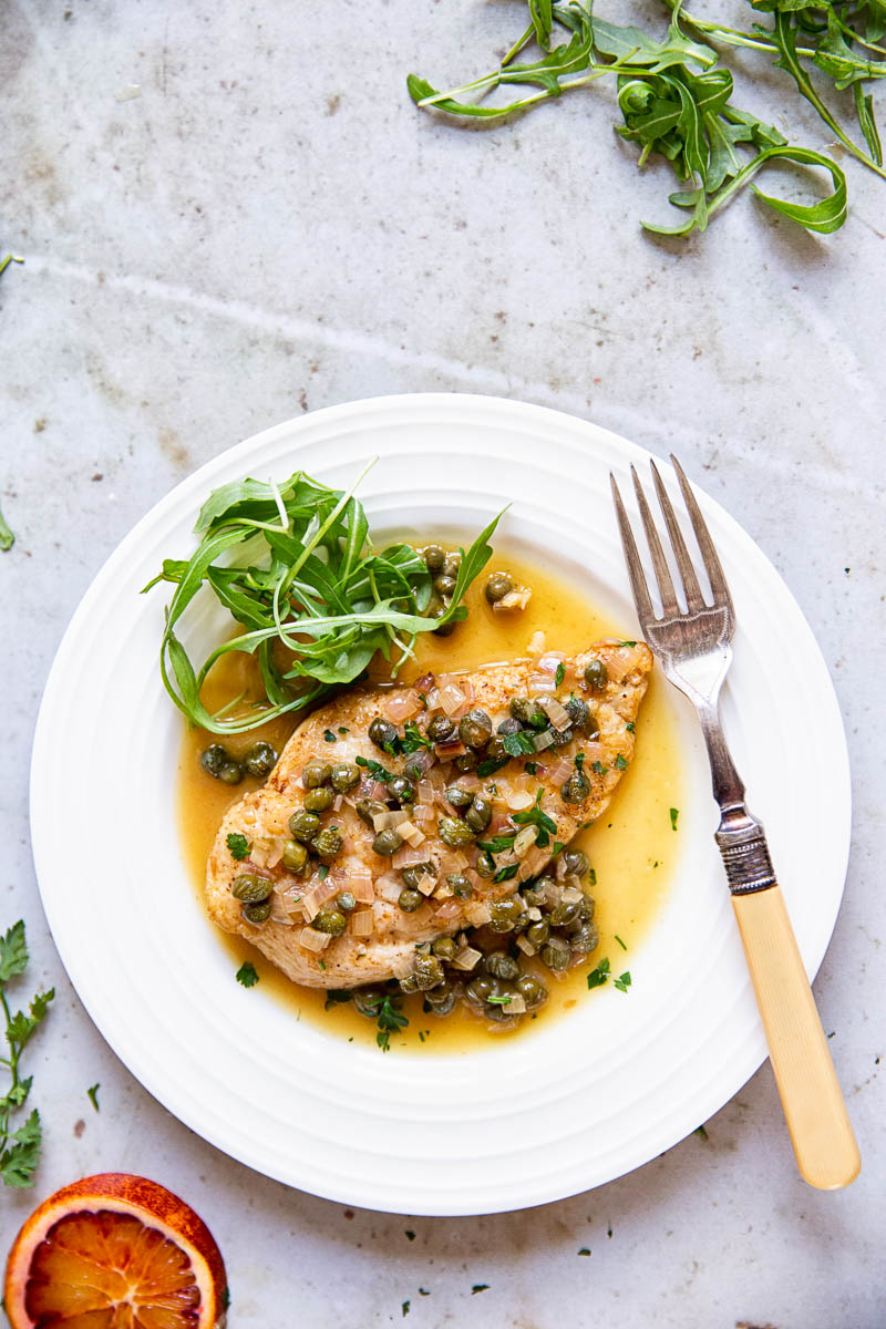 Chicken Paillard in Sherry Caper Sauce on white plate