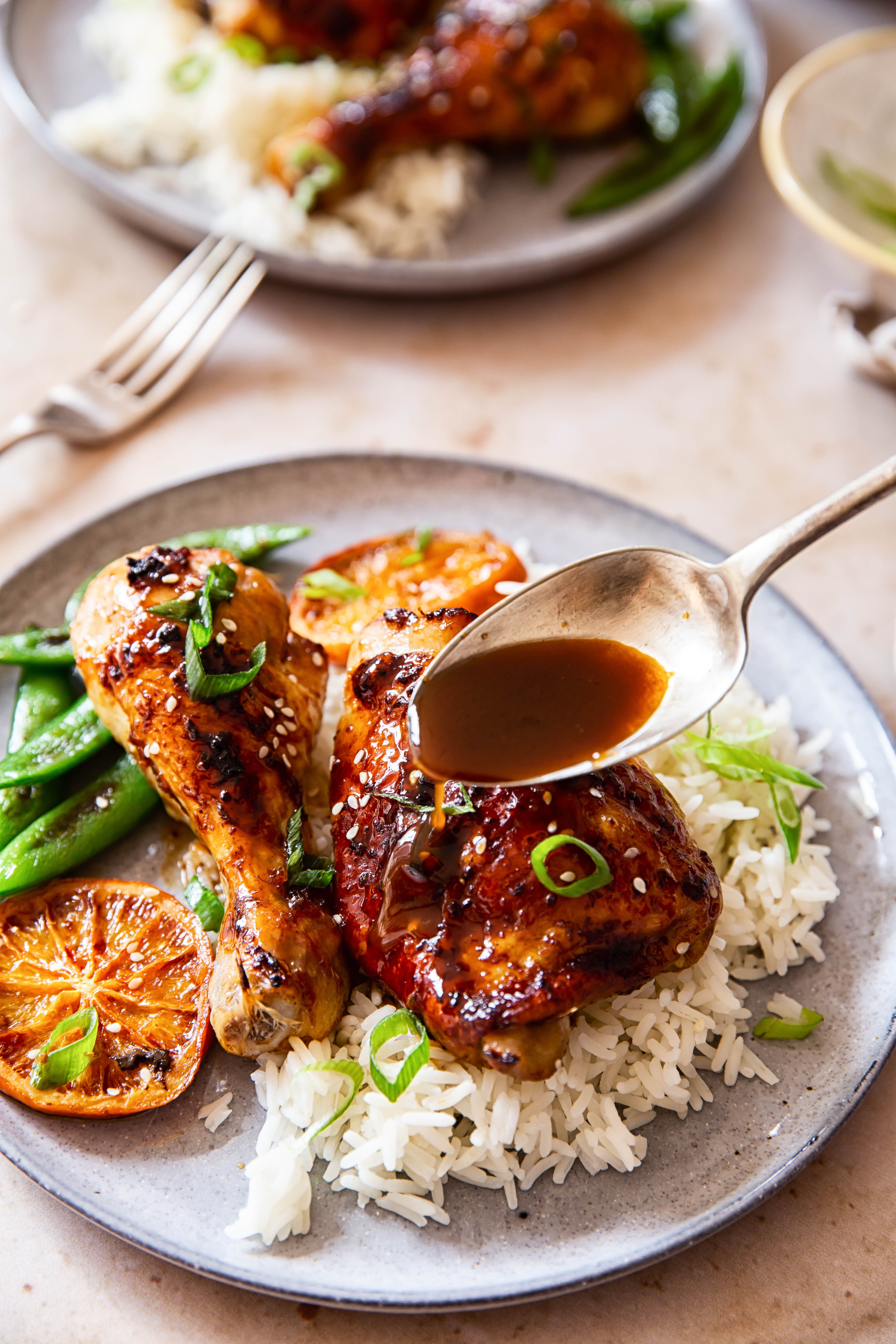 Honey Soy Chicken sprinkled with green onion and sesame seeds over white rice.