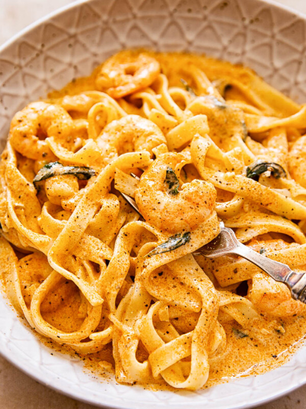 Prawn pasta in creamy tomato sauce in brown bowl