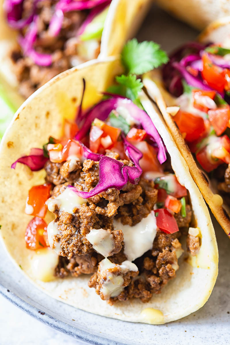 Beef Tacos topped with salsa and red cabbage slaw