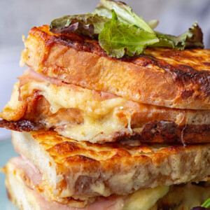 Croque Monsieur Sandwiches stacked on a plate