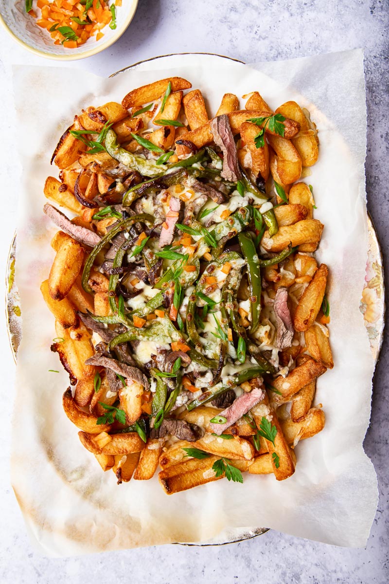Fries loaded with steak, green peppers and melted cheese.