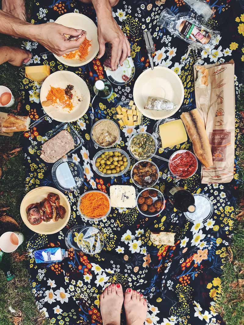 Top down view of a Parisian picnic, with bread, cheese and charcuterie