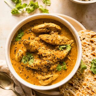 Chicken Korma with a side of naan bread and brown basmati rice.