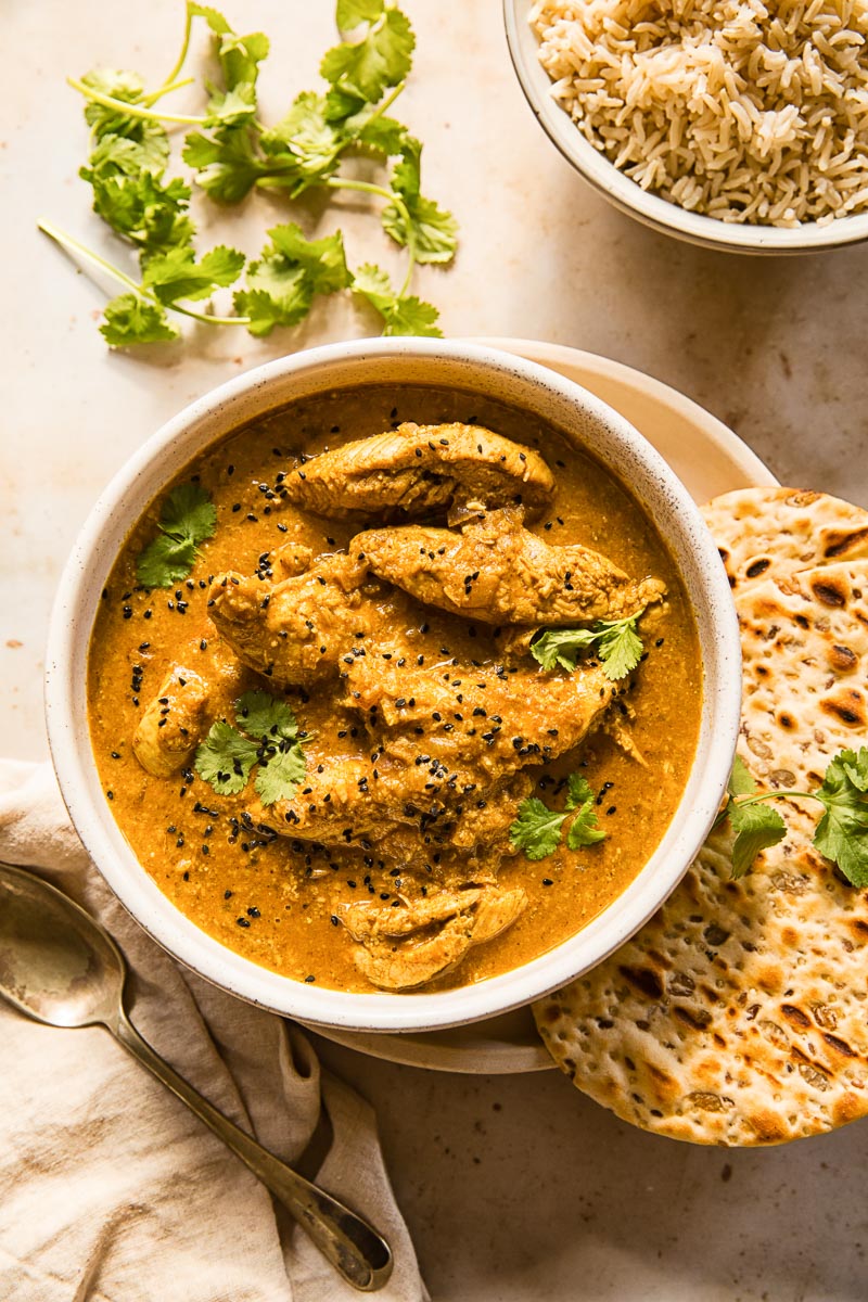 Chicken Korma with a side of naan bread and brown basmati rice.