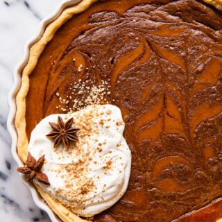 Pumpkin pie with chocolate swirl and whipped cream.