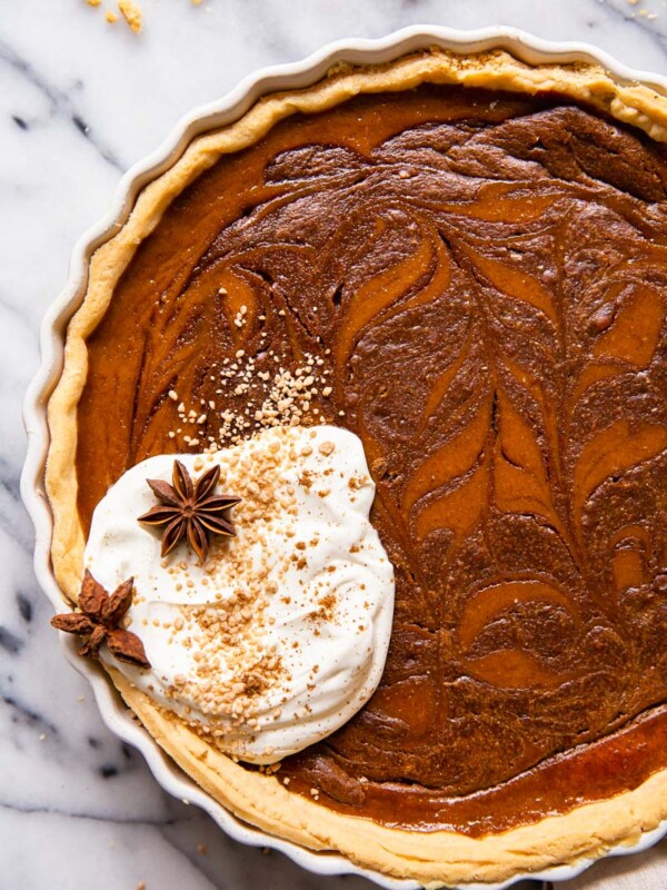 Pumpkin pie with chocolate swirl and whipped cream.