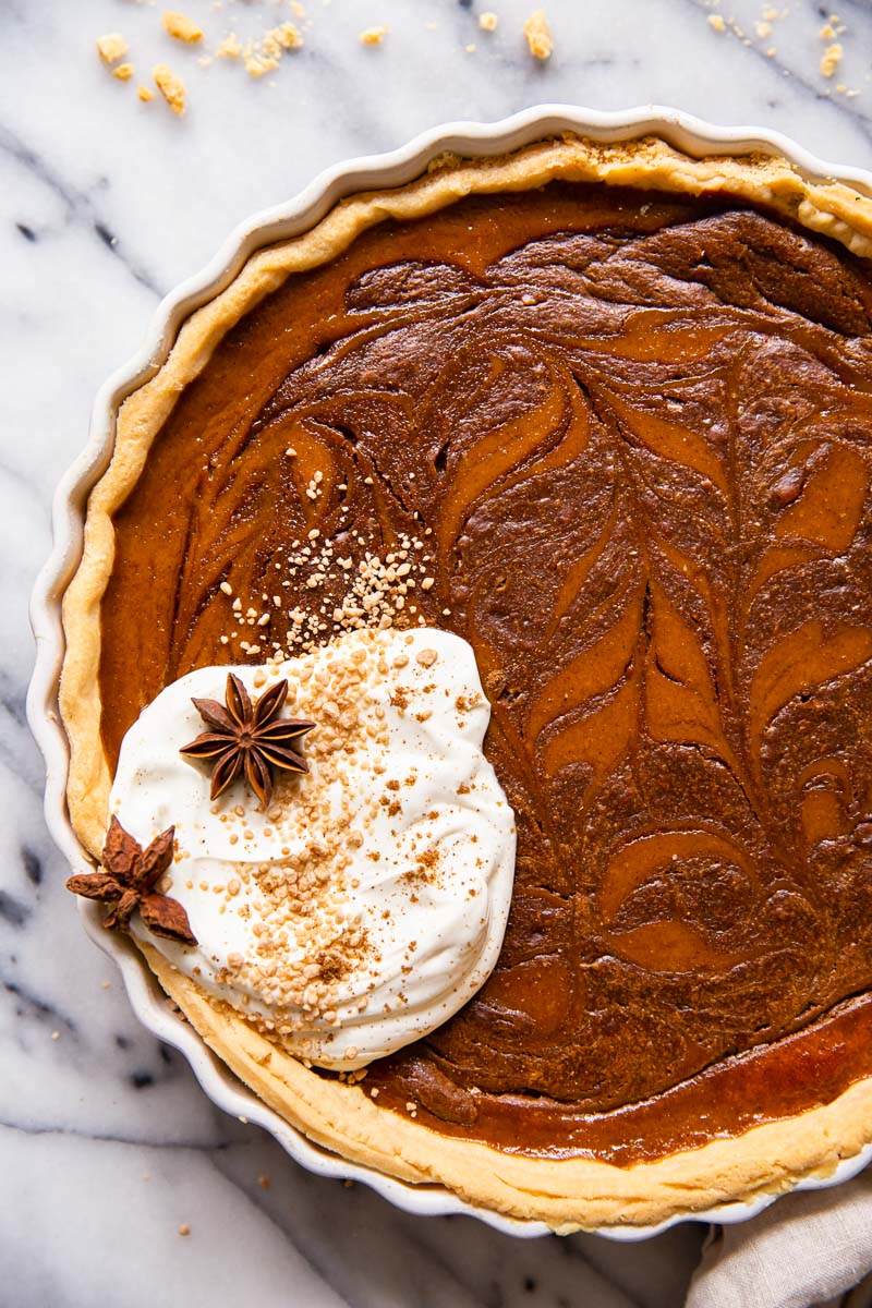 Pumpkin pie with chocolate swirl and whipped cream.