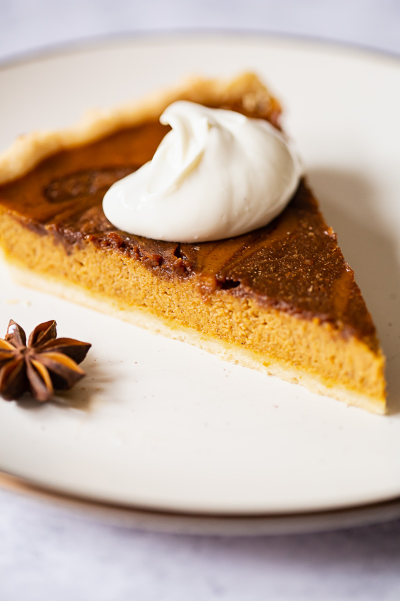 pumpkin pie slice with whipped cream on top