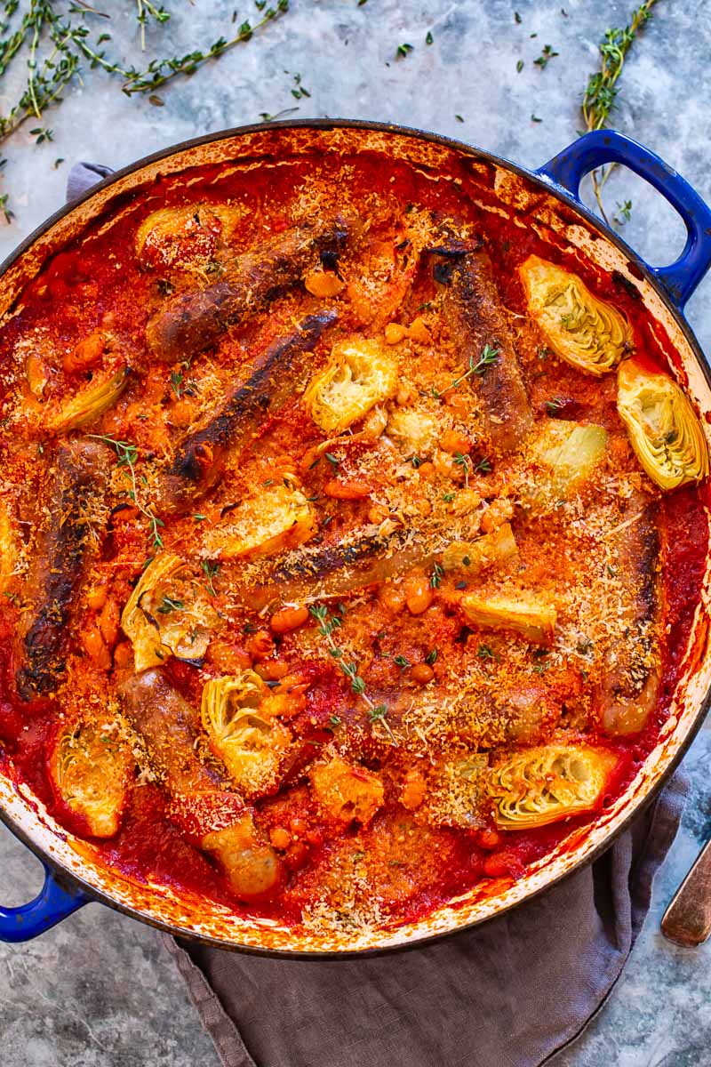 Sausage casserole with white beans and artichokes in tomato sauce.