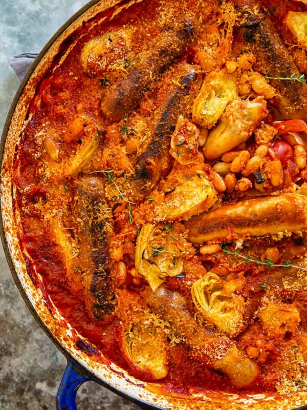Sausages cooked in smoky tomato sauce with white beans and artichokes.