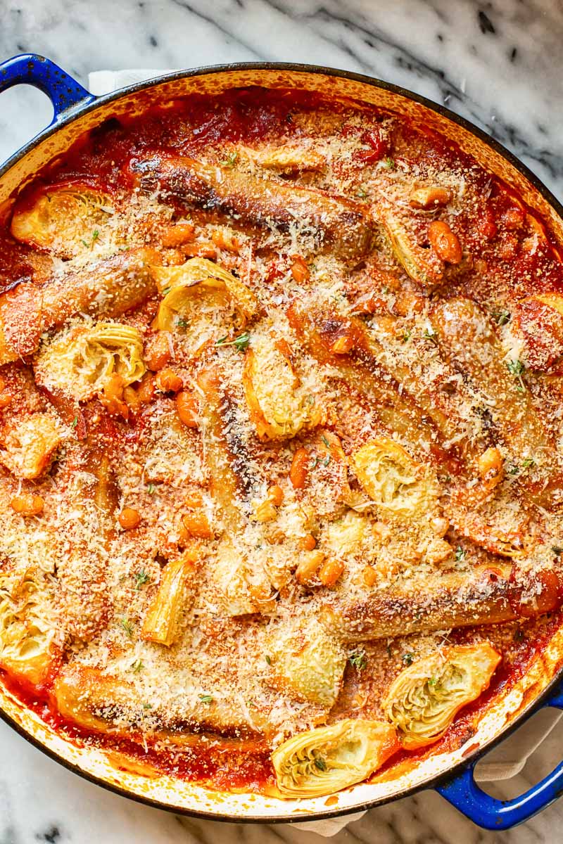 Sausage casserole with white beans and artichokes in tomato sauce