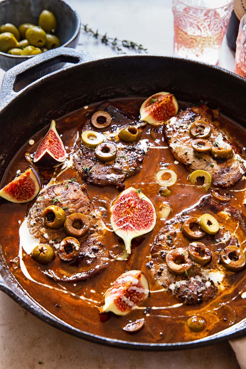 sweet and sour pork chops in sauce with olives and figs