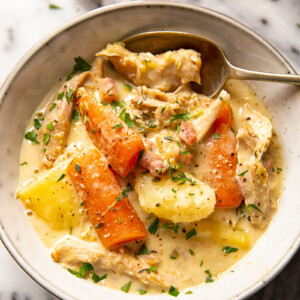creamy turkey stew with carrots and potatoes in grey bowl