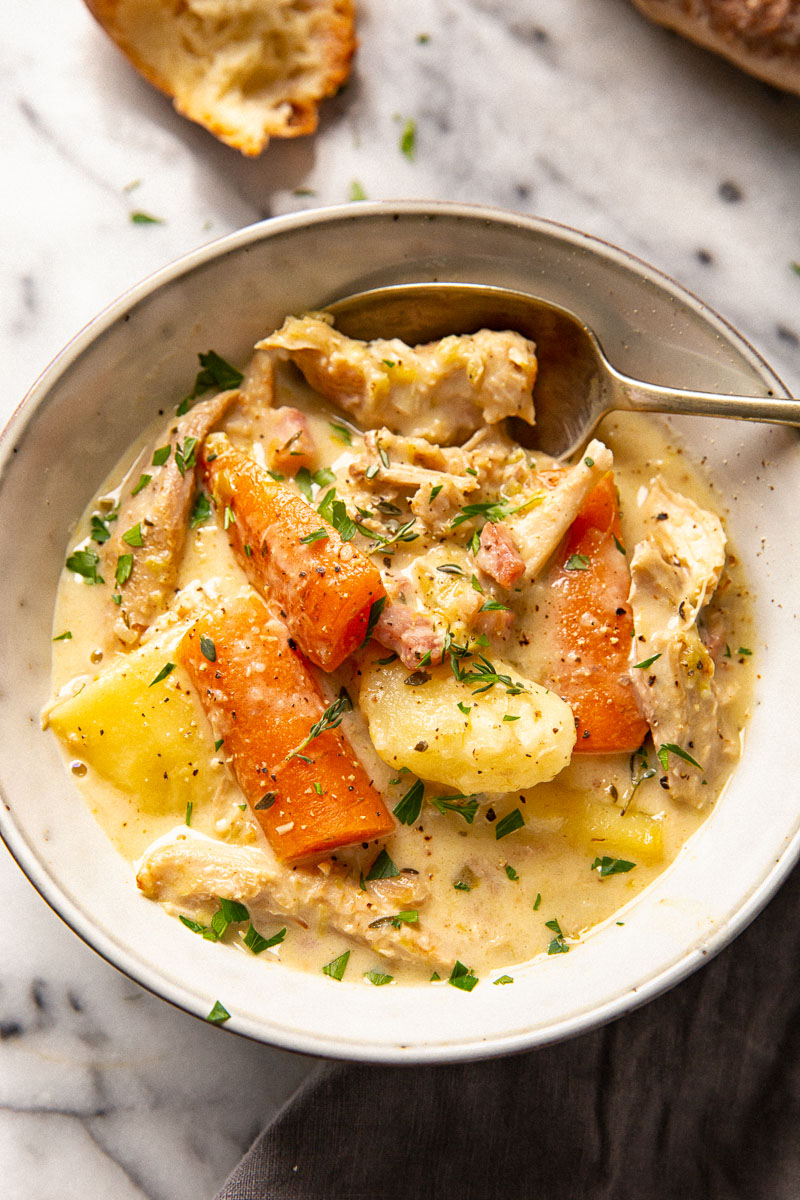 creamy turkey stew with carrots and potatoes in grey bowl