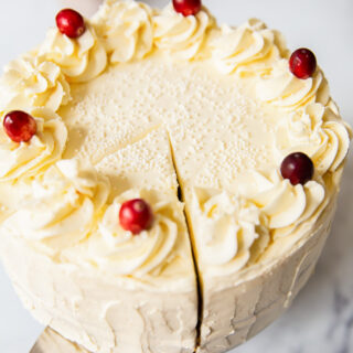 Cranberry Cake with Cream Cheese Icing and topped with fresh cranberries