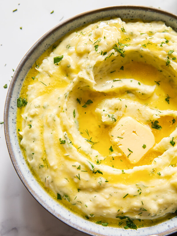 creamy mashed potatoes with melted butter and herbs