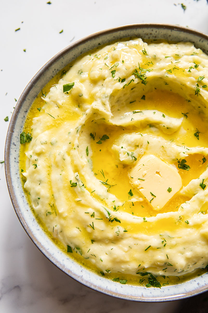 creamy mashed potatoes with melted butter and herbs