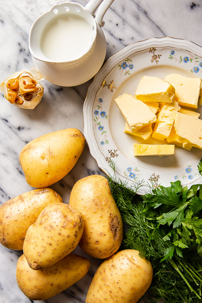 Mashed potato ingredients. Potatoes, butter, milk plus herbs and garlic for extra flavour. 