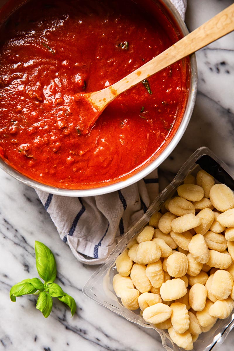 Bolognese sauce and gnocchi on marble