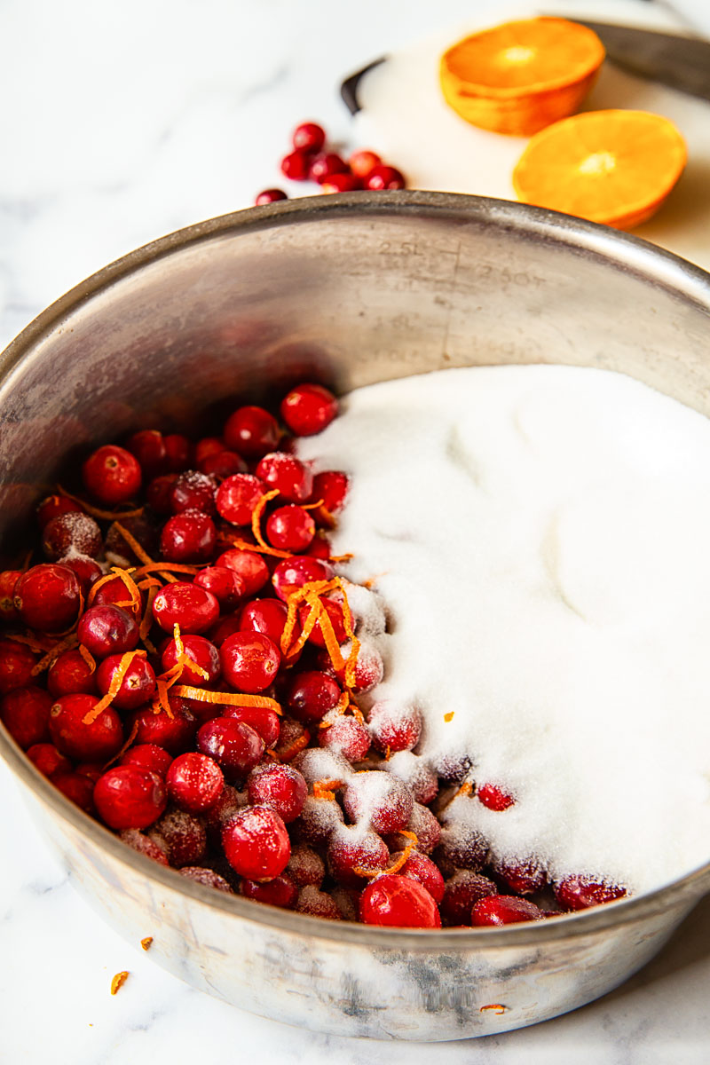 fresh cranberries with sugar and orange zest in a pot