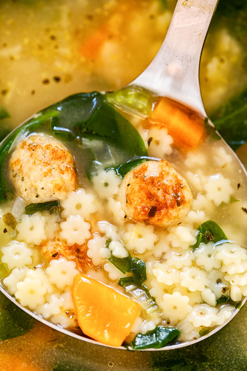 Italian wedding soup in a ladle 