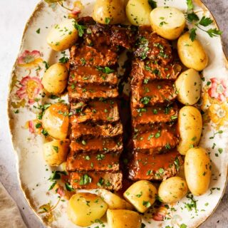 beef brisket and potatoes on platter
