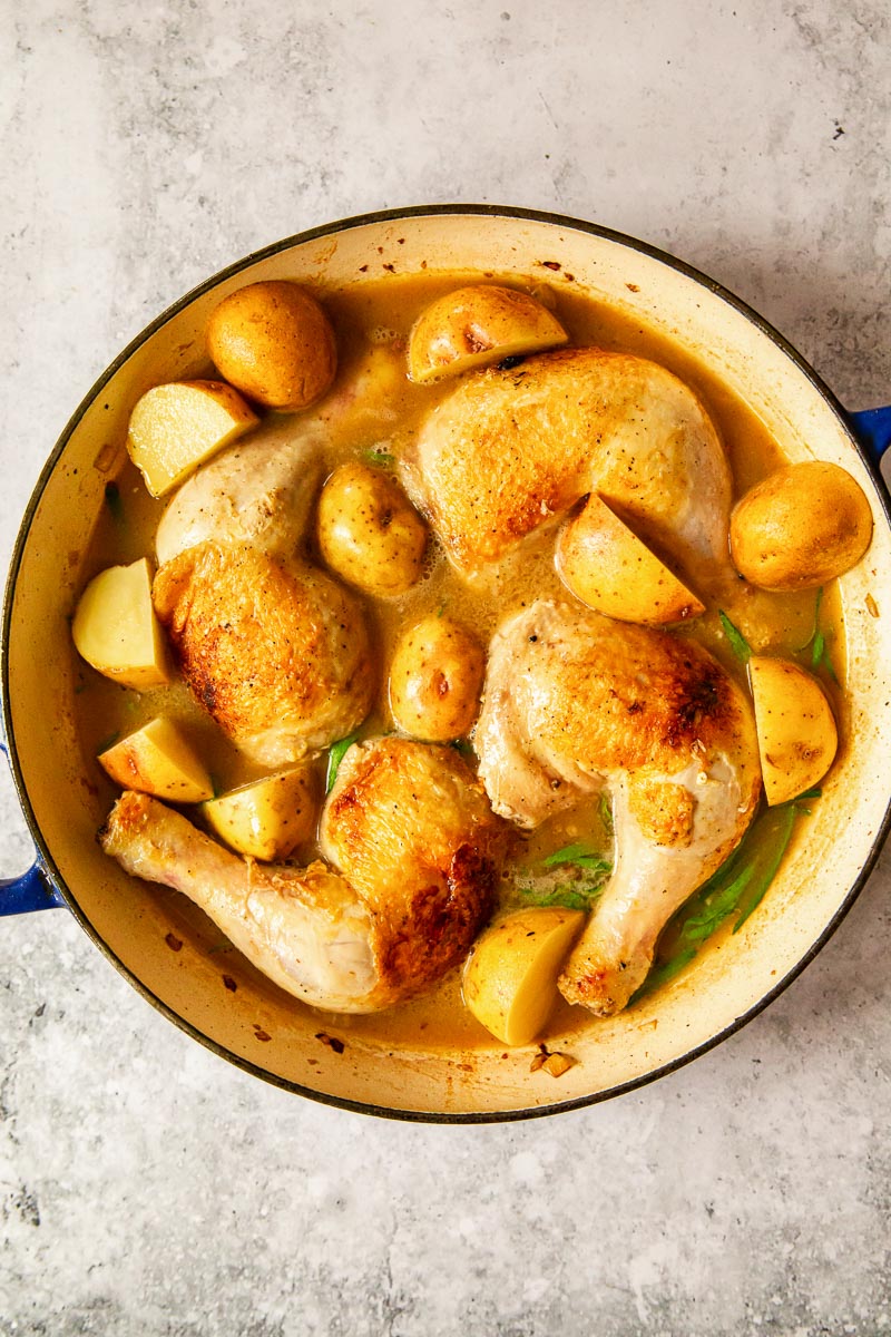 chicken legs and potatoes in cast iron casserole 