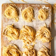 homemade tagliatelle and tagliolini on wooden board