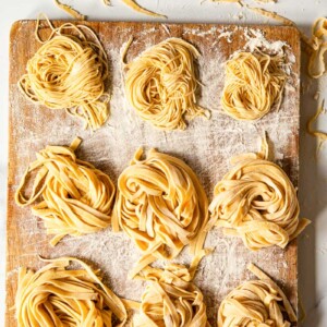 homemade tagliatelle and tagliolini on wooden board