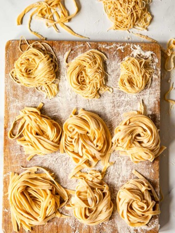 homemade tagliatelle and tagliolini on wooden board