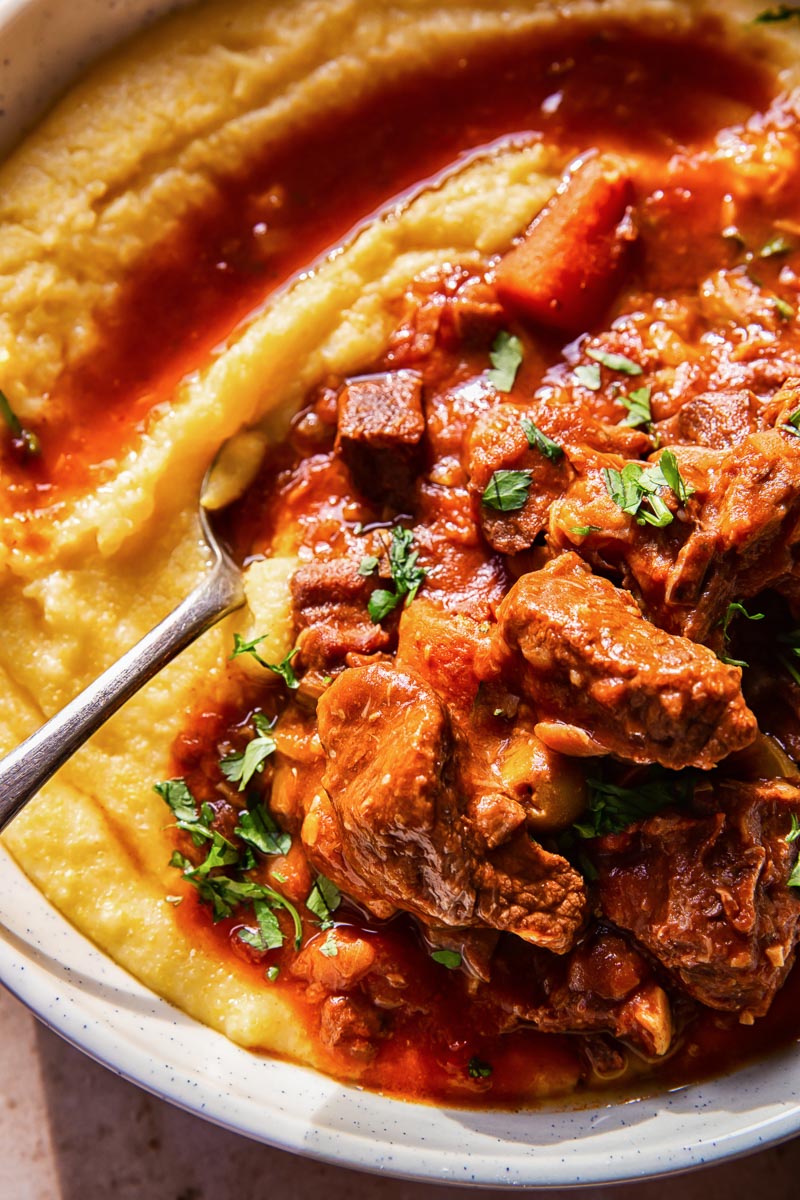 beef stew over polenta in a bowl