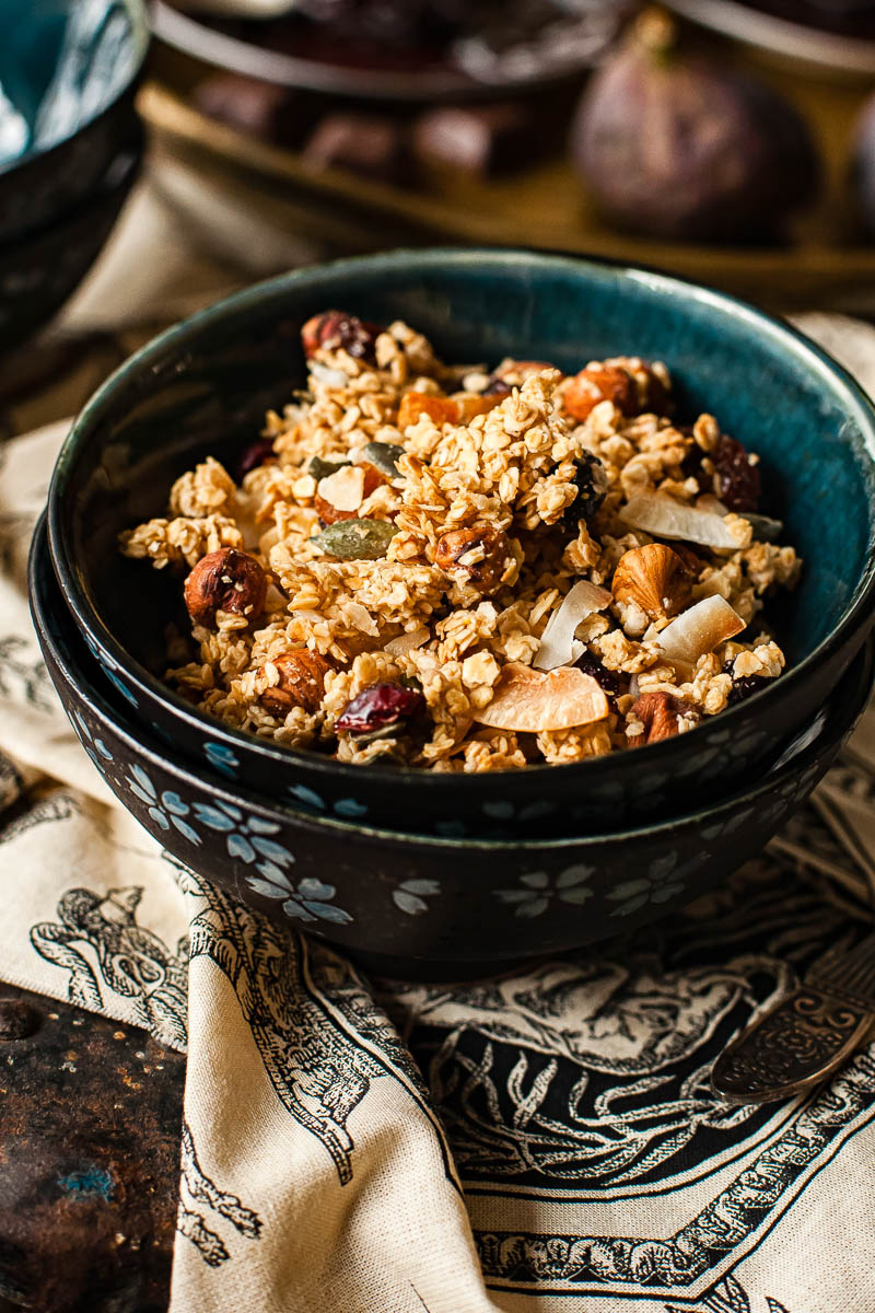 side view homemade granola in a blue bowl 