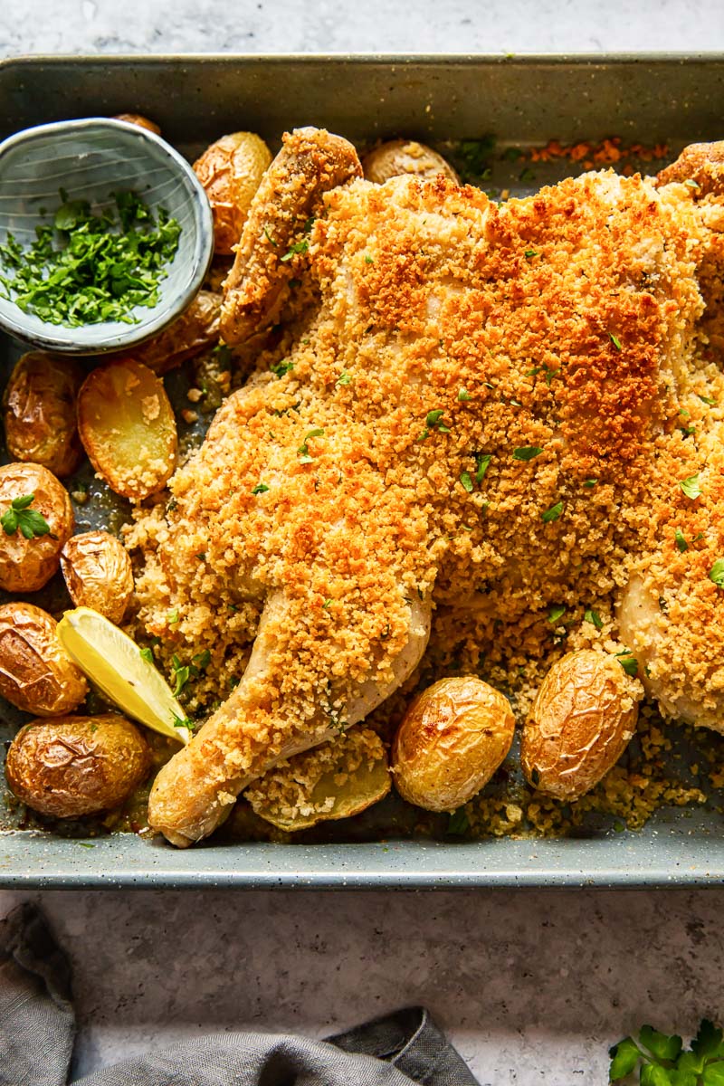 spatchcock chicken coated with breadcrumbs and roast potatoes