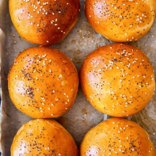 bread rolls sprinkled with poppy seeds and sesame seeds