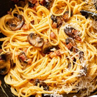 spaghetti carbonara with mushrooms in a pan