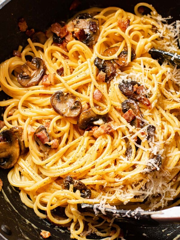 spaghetti carbonara with mushrooms in a pan