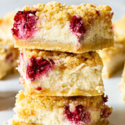 3 raspberry cheesecake bars stacked on top on each other