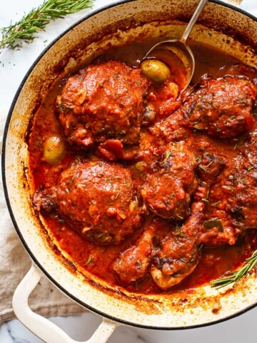 chicken in tomato sauce in white pan