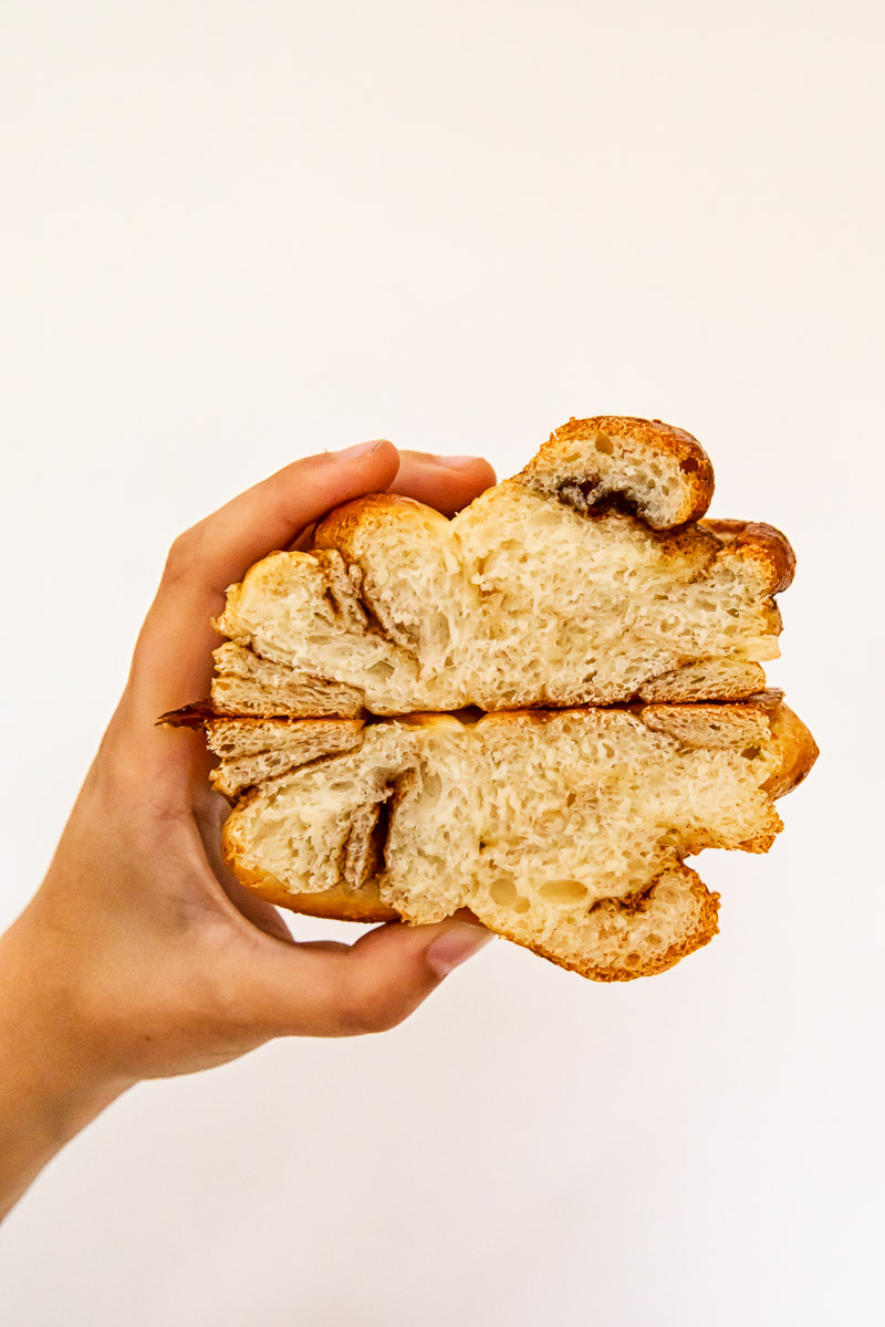 cinnamon bun cut in half with interior crumb showing