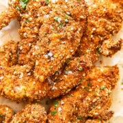 Chicken fingers in crispy coating on brown paper