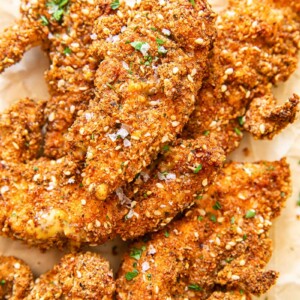 Chicken fingers in crispy coating on brown paper
