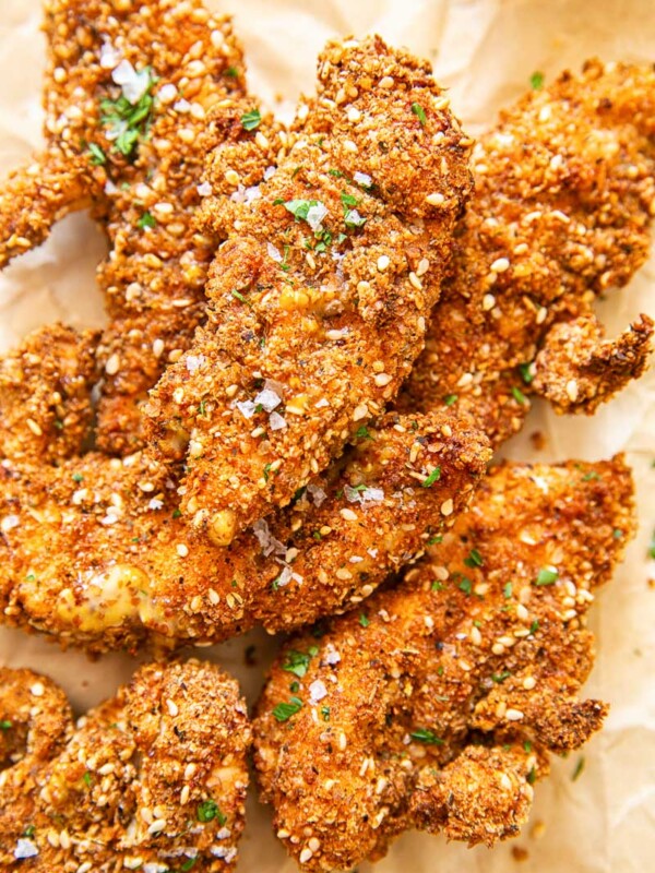 Chicken fingers in crispy coating on brown paper