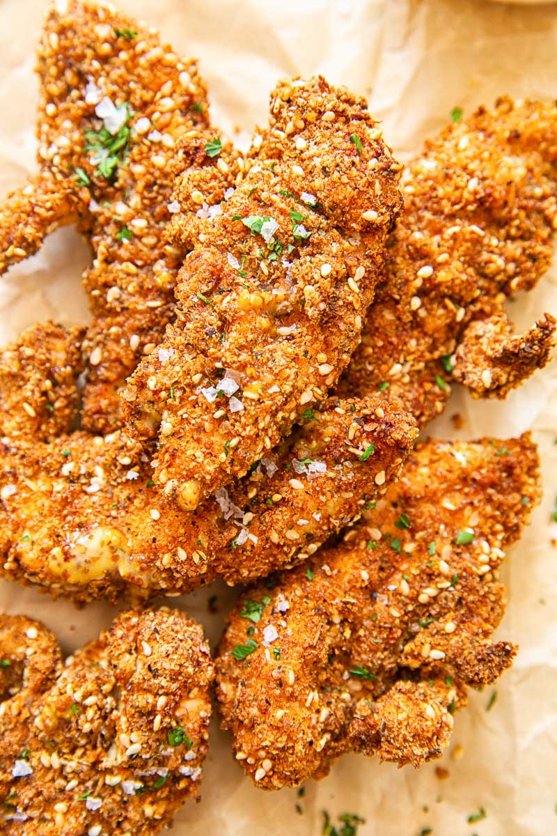 Chicken fingers in crispy coating on brown paper