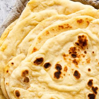 stacked flatbread on grey cloth napkin